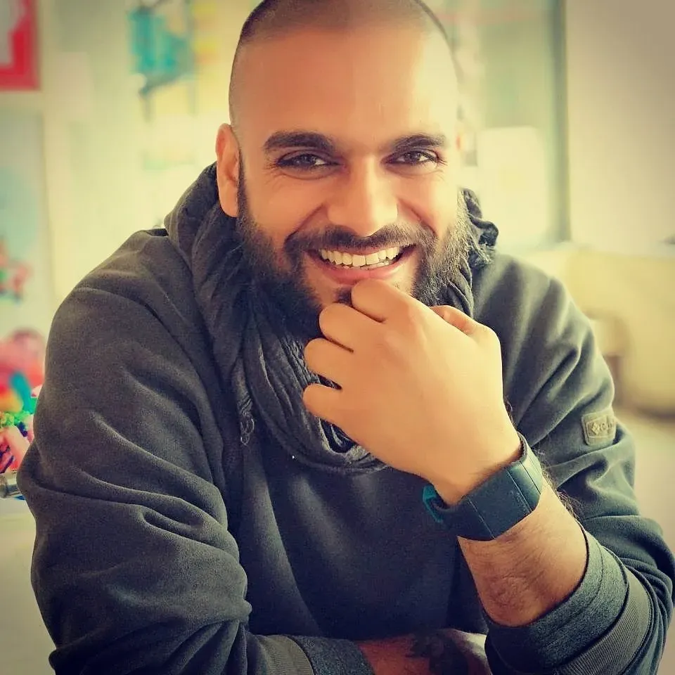 Smiling portrait of Akhil, hand to chin