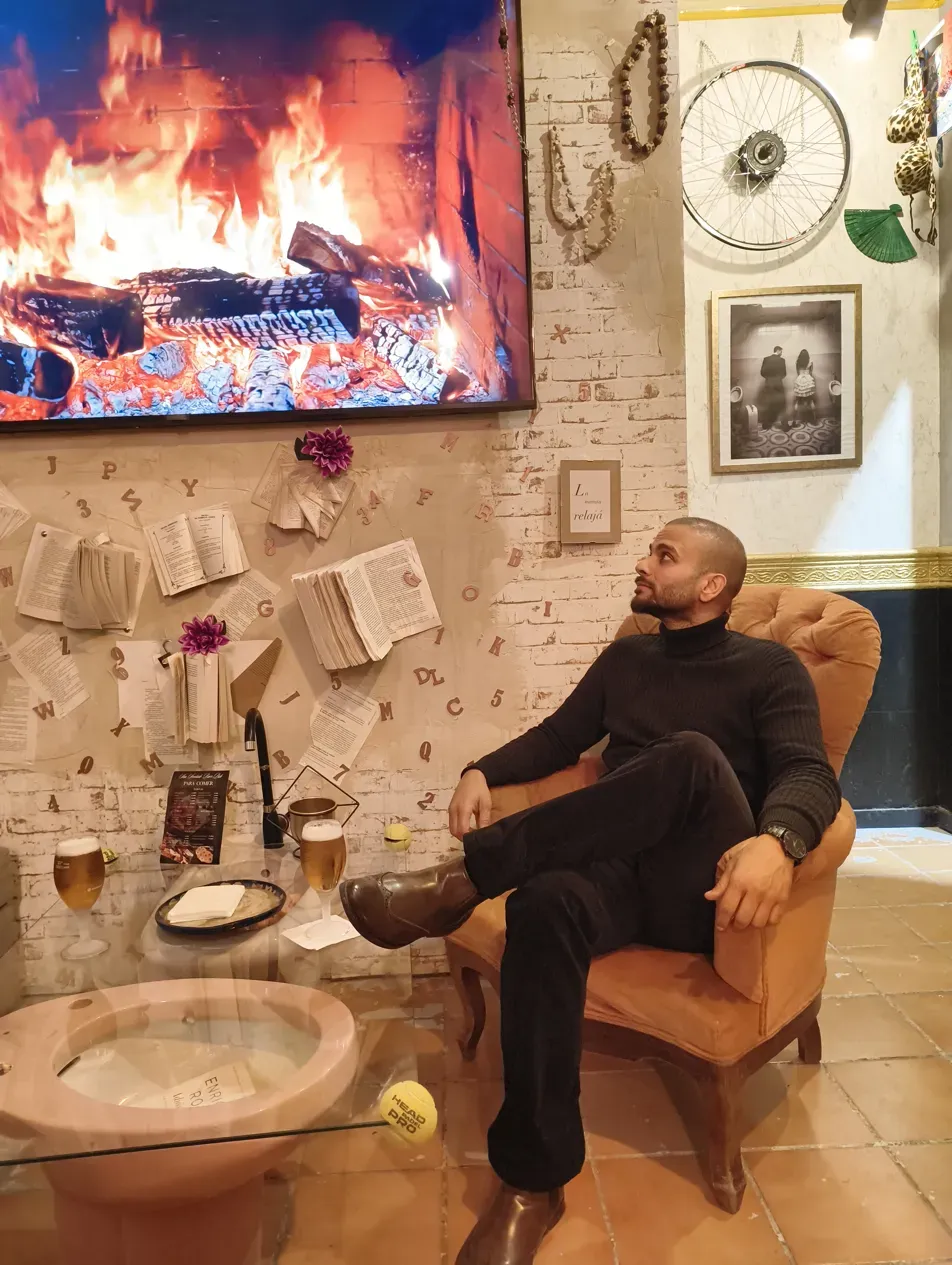 Bar interior in Seville with fireplace and pinned book pages